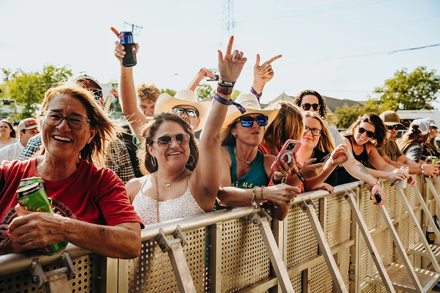 Festivalgoers cheering at the front barricade at Feels Like Home Festival