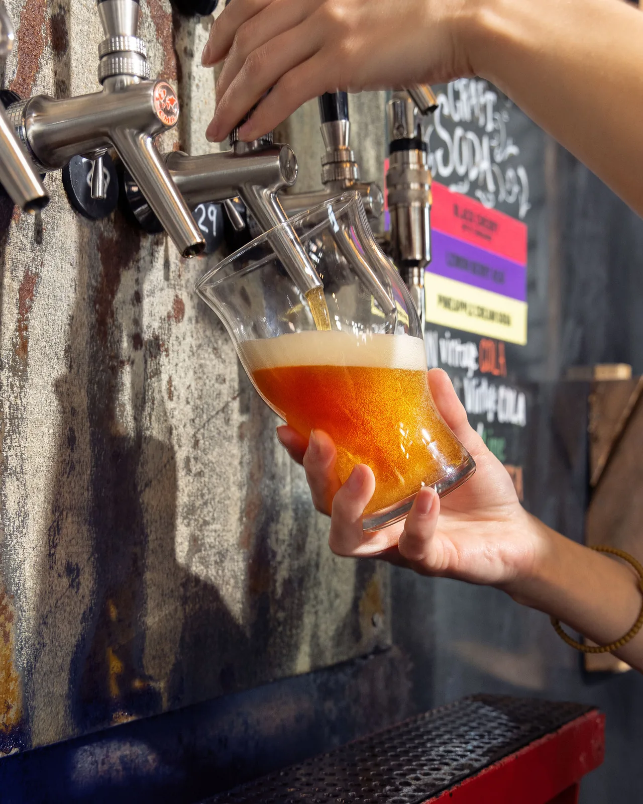 A glass of Texas craft beer being poured from the tap