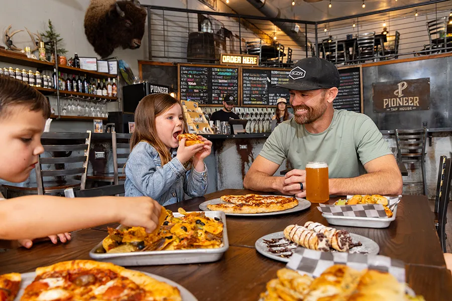 A family sharing pizza at Pioneer Tap House in Downtown Brownwood